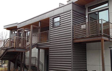 terra bronze siding on house with restic metal roof|western rib metal roofing.